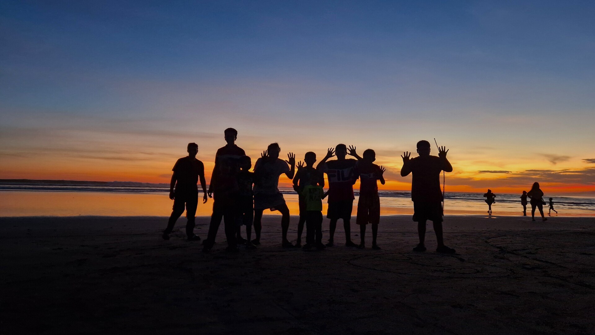 Group at the beach during sunset